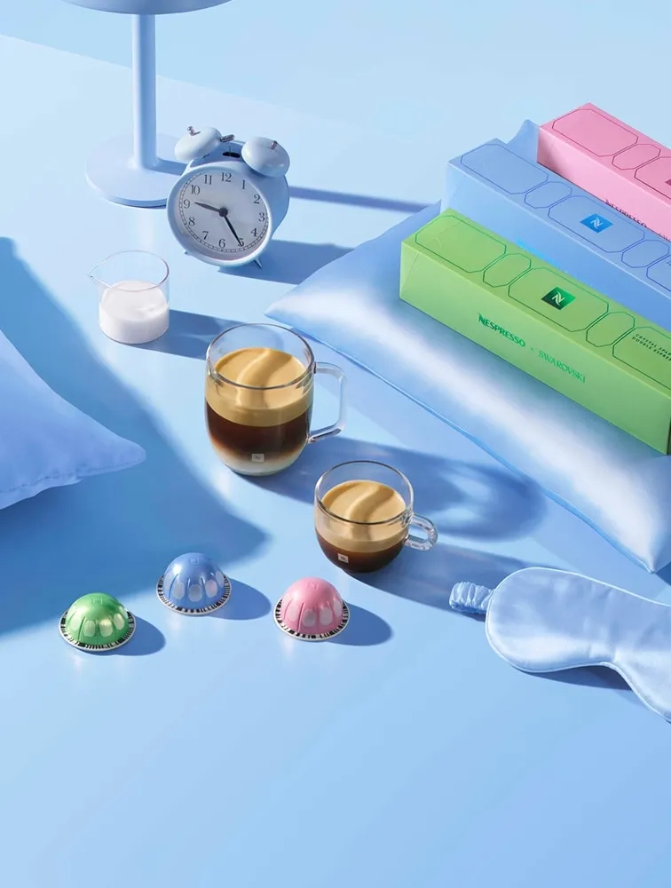 Crystal Spark Espresso Vertuo capsules and cups beside Nespresso x Swarovski capsule boxes
