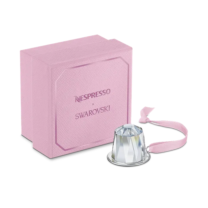 Swarovski crystal ornament shaped like a Nespresso Original capsule, in a pink gift box